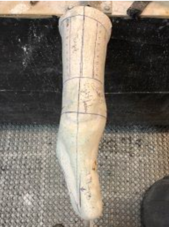 Positive plaster model of a boney below knee prosthetic patient with alignment lines